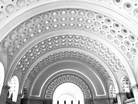 An old ornate building archway with carved octagons and rectangles.