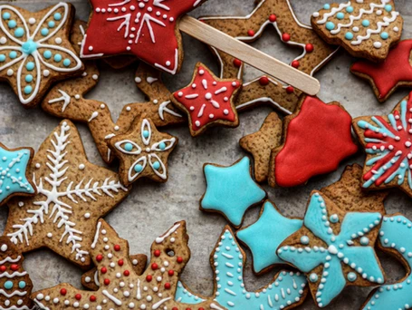 Gingerbread Cookies in the shape of stars with red, white, and light blue frosting decorations.