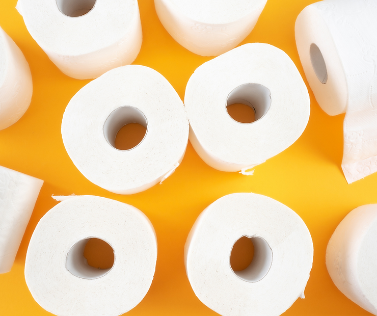 Rolls of white toilet paper on a yellow background.