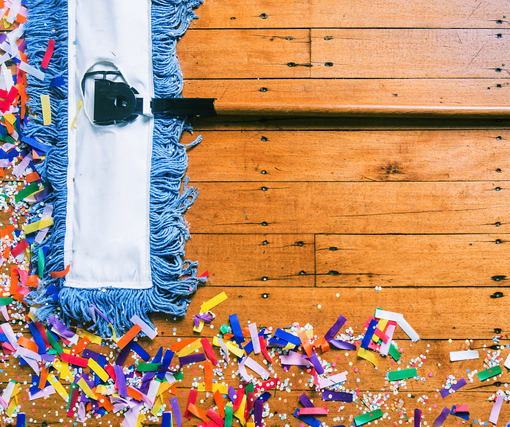 A dry mop cleaning confetti off a wood floor after a party.