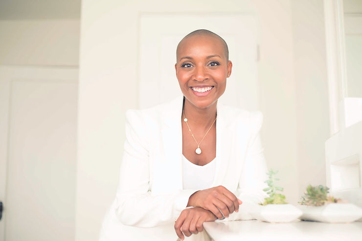 PopUp CleanUP CEO Kenetia Lee in a white business suit and jacket in a white room.