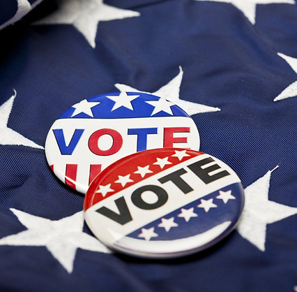 Two vote buttons lying on the stars part of a flag.