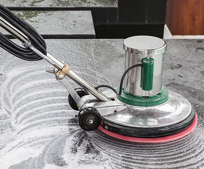 A heavy duty floor buffer circling the floor with soap and water.