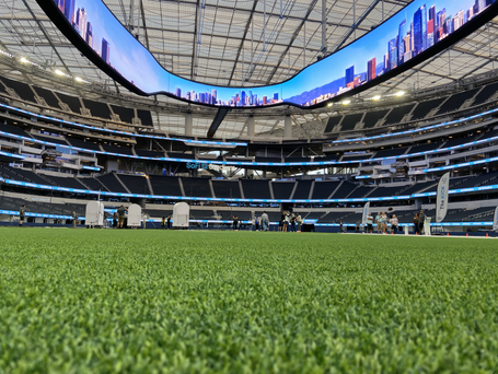 SoFi Football field worm's eye view looking up at the stadium and the digital screen that circles the upper part of the stadium.