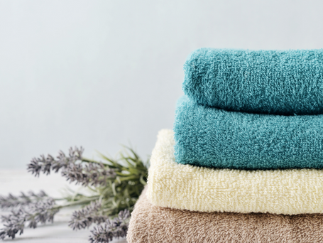 A pile of blue, cream, and beige folded towels