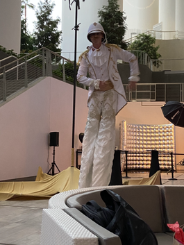 Entertainer walking on stilts at the FêteLA event at SoFI Stadium
