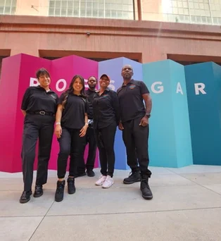 The PopUp CleanUp crew in front of a multi-colored wall at the Row DTLA for a Popsugar branding activation.