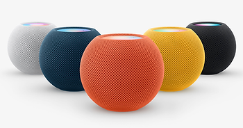 Five Home Pod minis in an assortment of colors: white, navy blue, orange, yellow, and black.