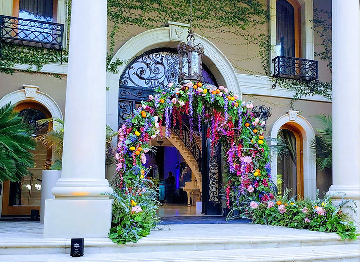 An exquisite floral archway set up for P&G's Secret Deodorant branding activation in front of the entryway of a Beverly Hills mansion.