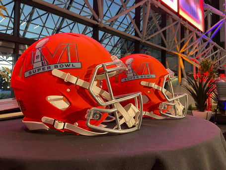 Two Orange football helmets with LVI Super Bowl logos on them at the 2022 NFL Business Connect Party.