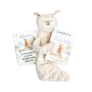 A furry alpaca puppet holding a baby book about alpacas.