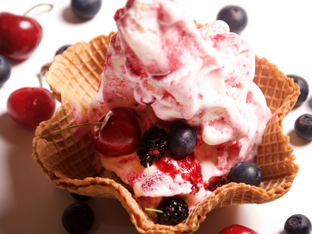 Cherry Ice cream in a waffle dish garnished with cherries, blackberries and blueberries