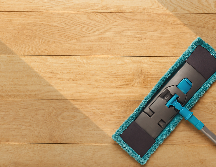 Blue microfiber mop wiping across a wood floor.