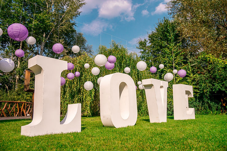 Love Sign with Chinese Lanterns on grass: one of 2024's top event trends is customized decor.