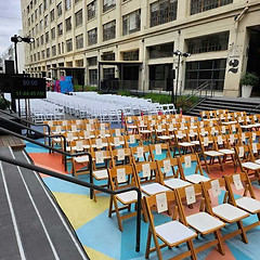 Folding chairs arranged on a colorful blue, orange, and yellow mat at the Row, DTLA for the Popsugar event