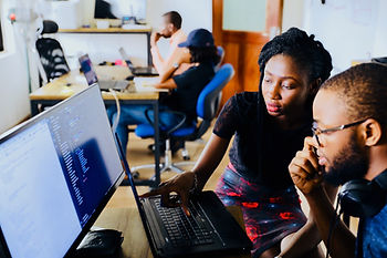 Two African Americans looking at a computer websites in a post for how to search online for where to donate.