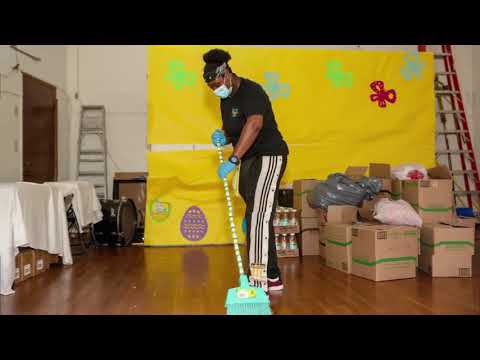 A PopUP CleanUP cleaner sweeping wood floors with a yellow screen decorated with Easter Eggs and butterflies in the background.