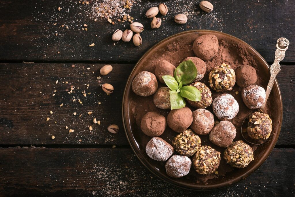 Chocolate truffles in a brown wooden bowl