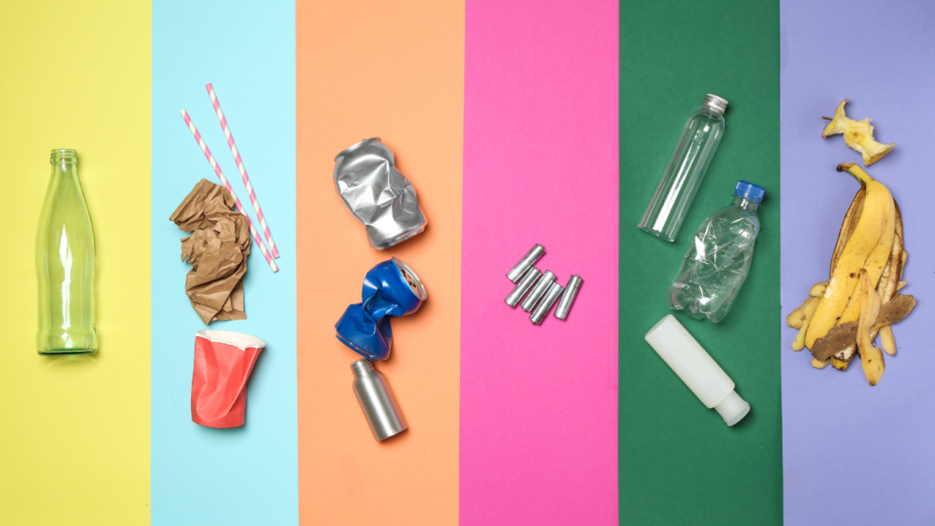 Various types of waste that can be recovered, recycled, or composted: glass, paper, aluminum, batteries, banana peel and chewed up apple core.