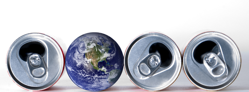 Three aluminum cans and a globe of the world lined up as a metaphor for sustainability.