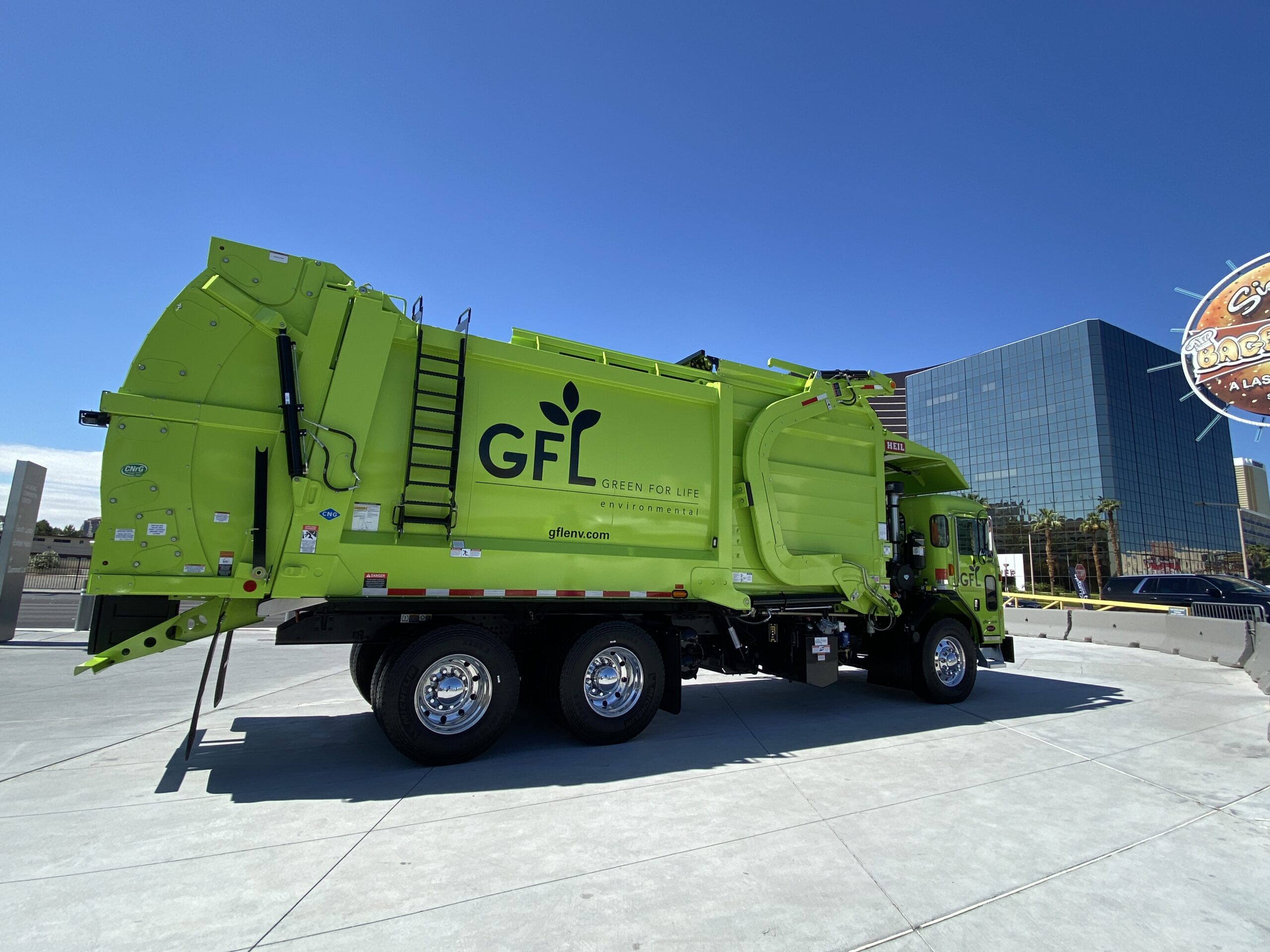 A lime green GFL waste truck on display at Waste Expo in Vegas.